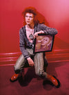 A fine art limited edition print of David Bowie with the album cover of 'Hunky Dory', taken by Mick Rock, displayed against a red background.