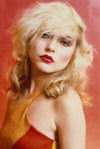 A fine art photograph of Debbie Harry, Blondie, 1978, by Mick Rock, with a signature stamp and a yellow abstract background.