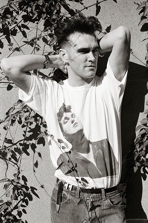 Morrissey in 1991, wearing a t-shirt with a portrait, captured during the 'Kill Uncle' tour by Kevin Cummins.