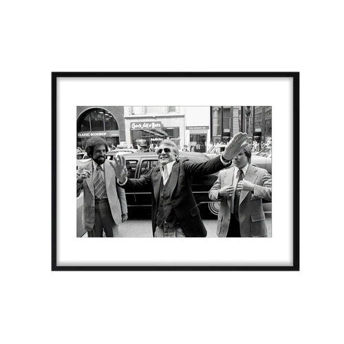 Actor Steve martin photographed on the street in nyc with hands up and smiling. 