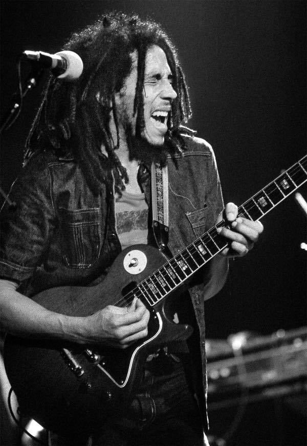 Fine art Black and white photo of Bob Marley performing on stage, 1975 shot by Mick Rock. 