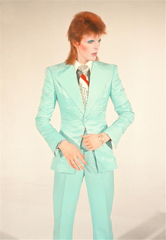 A fine art limited edition print of David Bowie in a mint green suit against a cream background for the video 'Life On Mars' shot by Mick Rock. .
