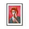A fine art limited edition print of David Bowie with red hair, wearing a glittery shirt on a pink background, posed with a serious expression.
