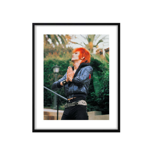 A limited edition fine art photograph of David Bowie, known as Ziggy Stardust hands praying at the Beverly Hills Hotel. The image is embossed with Mick Rock's signature stamp.