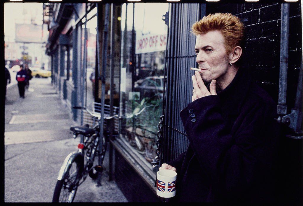English singer and songwriter David Bowie smoking a cigarette in New York City, in front of Tea &amp; Sympathy on January 10, 1997.