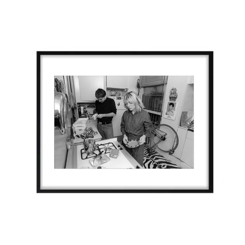 A black and white framed photograph of Debbie Harry and Chris Stein of Blondie in a kitchen setting, taken by Allan Tannenbaum in 1980.