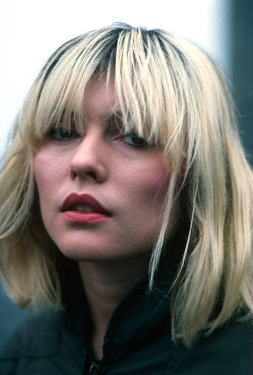 A color portrait of Debbie Harry from 1980, showing her with a serious expression.