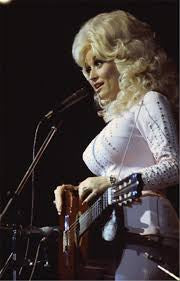 A fine art photo of Dolly Parton singing, with a close-up on her performing. Shot by Mick Rock. 