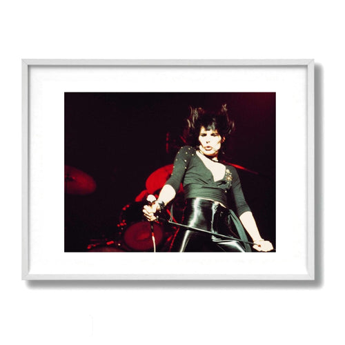 A framed color fine art photograph of Freddie Mercury of Queen on stage performing.  shot by Mick Rock. 