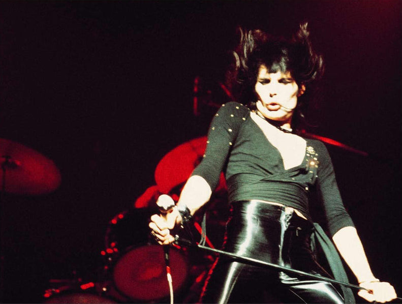 A color fine art photograph of Freddie Mercury of Queen on stage performing.  shot by Mick Rock. 