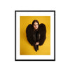 A fine art limited edition print framed featuring a close-up portrait of Lana Del Rey with a black dress and black fur jacket, against a yellow background.