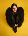 A fine art limited edition print featuring a close-up portrait of Lana Del Rey with a black dress and black fur jacket, against a yellow background.