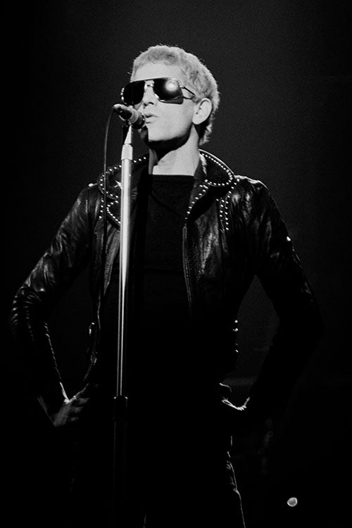 Black and white photo of Lou Reed performing in Manchester England in 1974. 