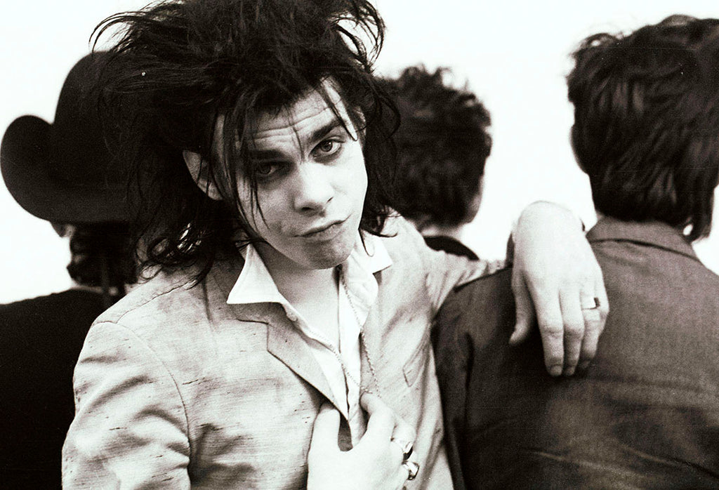 Nick Cave, 1983, in a striking portrait with The Birthday Party at Hacienda, Manchester, photographed by Kevin Cummins.