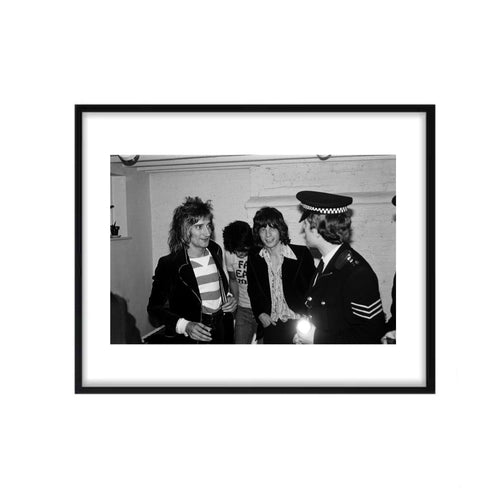 A black and white photograph featuring Rod Stewart, Mick Jagger, and Ronnie Wood with The Police, 1975. shown framed. 