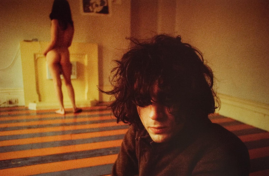 Syd Barrett of Pink Floyd during the session for his debut solo album "The Madcap Laughs". The nude woman in the background was an acquaintance of Barrett's known as "Iggy the Eskimo".