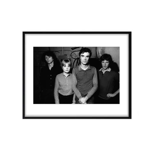 Black and white photo of the band Talking Heads standing together in NYC by photographer Allan Tannenbaum. 