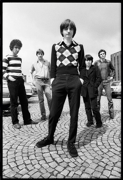 Black and white photo of Mark E Smith and band, The Fall. 