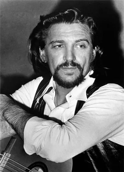 a black and white photo of waylon jennings. Shot by photographer Mick Rock. 