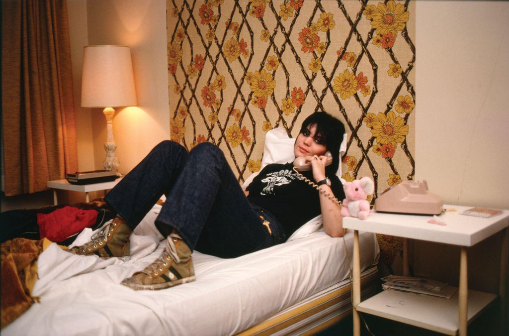 Joan Jett on the phone, bed, sneakers, color photo, by Brad Elterman, signed edition, limited edition, coffee table book, fine art photography, rock n roll, Los Angeles, Joan Jett, blondie, Debbie Harry, Ramones, David Bowie, kiss, Michael Jackson, iggy pop, sunset Blvd, art gallery, la Maison rebelle. 